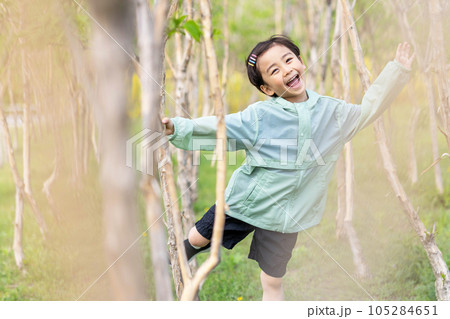 happy boy standing in the garden happy boy standing in the garden 105284651