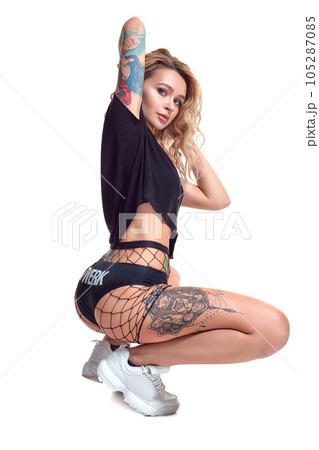 beautiful blonde girl in booty shorts and fishnet dancing twerk isolated on white background beautiful blonde girl in booty shorts and fishnet dancing twerk isolated on white background 105287085