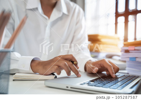 business man hand working with laptop computer, tablet and smart phone in office. business man hand working with laptop computer, tablet and smart phone in office. 105287587