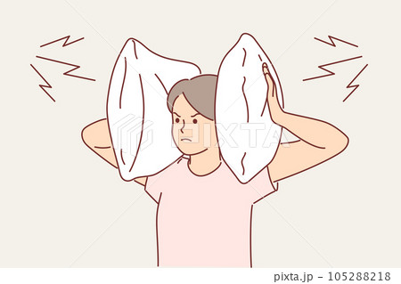 Irritated woman covers ears with pillow so as not to hear noise from neighbors who are having party Irritated woman covers ears with pillow so as not to hear noise from neighbors who are having party 105288218