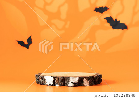 Creative Halloween composition with paper bats, podium and orange background. Modern Halloween aesthetic. Creative Halloween composition with paper bats, podium and orange background. Modern Halloween aesthetic. 105288849