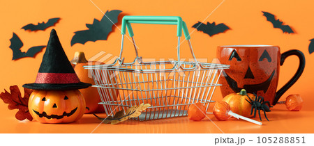 Spooky Halloween composition made of shopping basket and halloween decorations, sale. 105288851