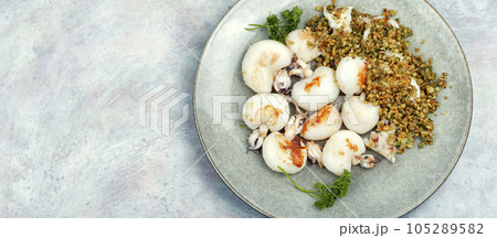 Baked calamari with nuts, space for text. 105289582