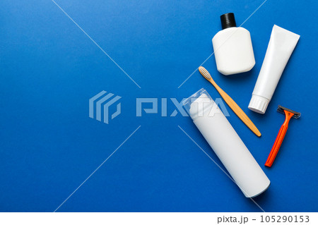 Composition with bath cosmetics on table. razor, toothpaste, soap, gel, toothbrush, mouthwash and other various accessories. Cosmetics for skin health. Bath Mockup for your logo 105290153