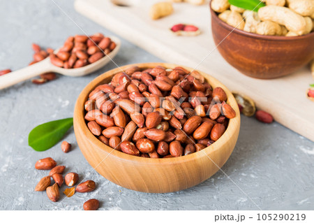 Fresh healthy peanuts in bowl on colored table background. Top view Healthy eating bertholletia concept. Super foods Fresh healthy peanuts in bowl on colored table background. Top view Healthy eating bertholletia concept. Super foods 105290219