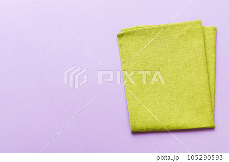 top view with green kitchen napkin isolated on table background. Folded cloth for mockup with copy space, Flat lay. Minimal style 105290593
