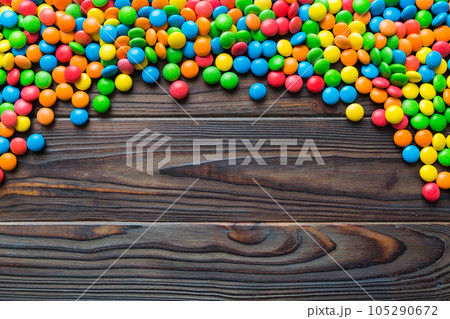 Mixed collection of colorful candy, on colored background. Flat lay, top view. frame of colorful chocolate coated candy 105290672