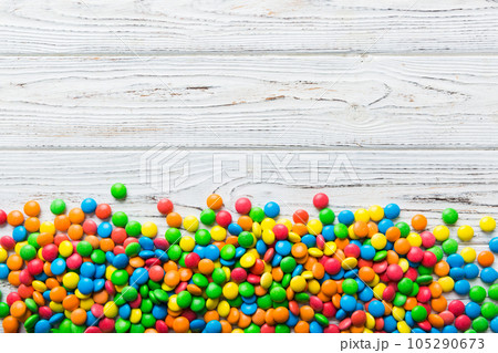 Mixed collection of colorful candy, on colored background. Flat lay, top view. frame of colorful chocolate coated candy 105290673