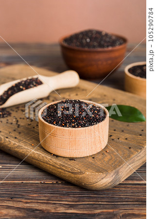 quinoa seeds in bowl and spoon on colored background. Healthy kinwa in small bowl. Healthy superfood 105290784