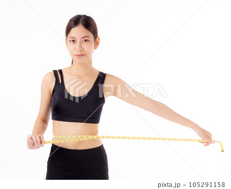 Portrait beautiful young asian woman measure tape with waist for weightloss with satisfied isolated. Portrait beautiful young asian woman measure tape with waist for weightloss with satisfied isolated. 105291158