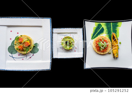 Vegetarian porridge quinoa with baked pumpkin and tomatoes and Vegetarian zucchini and avocado tartare with olive 105291252