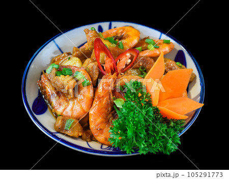 Salt fried shrimp with sauce and vegetables isolated on black backround Salt fried shrimp with sauce and vegetables isolated on black backround 105291773