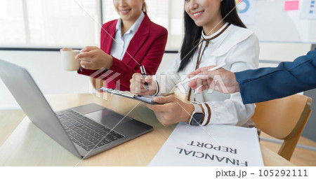 A group of Asian business people meets. have pointed to discussion graphs and data analysis charts and graphs of business finance and management concepts 105292111