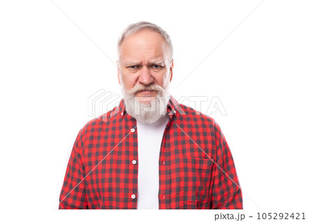 sullen 60s retired man with white beard and mustache in red shirt 105292421