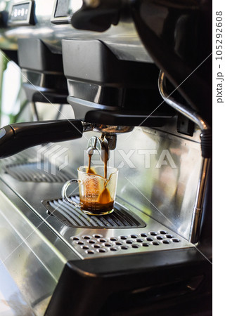 coffee machine making espresso in a cup close up 105292608