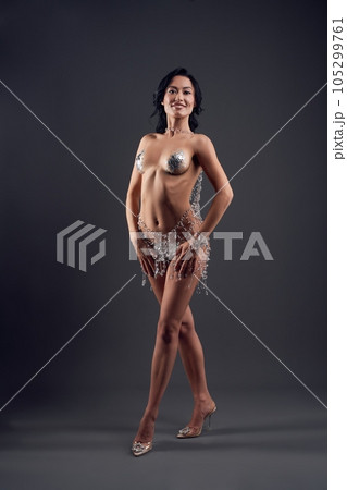 Attractive naked woman with glitter covering nipples 105299761