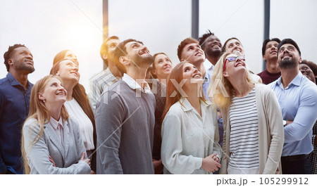 Active multiethnic male and female audience looking up 105299912