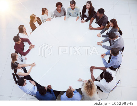 Business people having a meeting at round table Business people having a meeting at round table 105299948