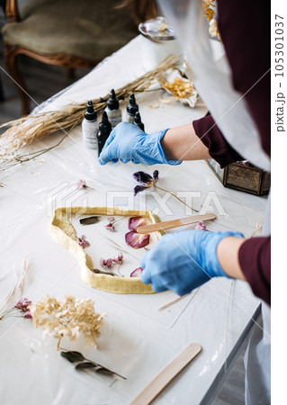 Side hustle, Money-Making Crafts, DIY Crafts To Create and Make Money. Epoxy Resin Art. Creating Art with Resin on workshop. The art process of creating epoxy resin handmade staff in art studio. 105301037