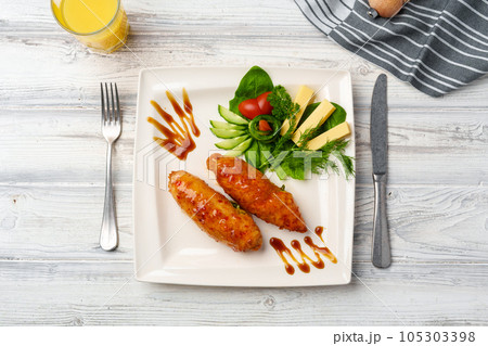 Chicken Adana kebap served with vegetables on white plate Chicken Adana kebap served with vegetables on white plate 105303398