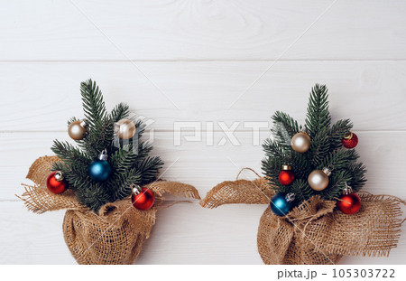 Christmas tree branches decorated with baubles on white background