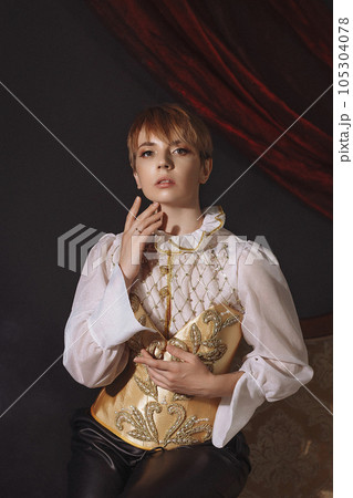Woman in a red vintage jacket embroidered with gold patterns  105304078