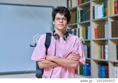 Portrait of confident guy college student looking at camera inside library Portrait of confident guy college student looking at camera inside library 105305057