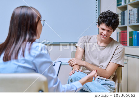 Young guy student at meeting with psychologist, college counselor in office 105305062
