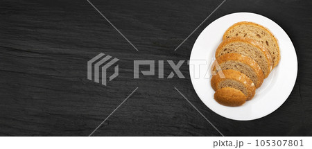 Brown Bread Slices on Black Plate Background 105307801