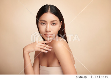Beautiful young asian woman with clean fresh skin on beige background, Face care, Facial treatment, Cosmetology, beauty and spa, Asian women portrait. 105312639