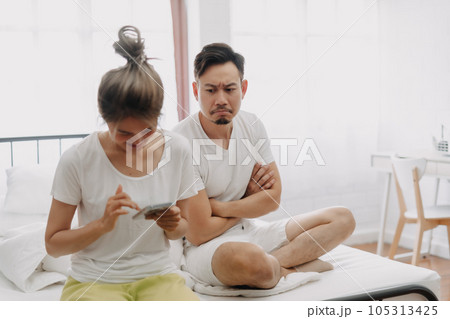 Husband peeking wife chatting on the phone if she might has an affair. 105313425