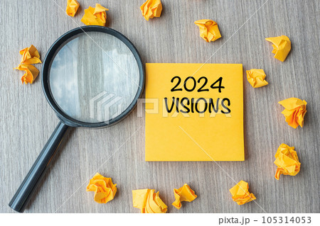 2024 VISIONS words on yellow note with crumbled paper and magnifying glass on wooden table background. New Year New Start, Idea, Strategy, and Goals concept 2024 VISIONS words on yellow note with crumbled paper and magnifying glass on wooden table background. New Year New Start, Idea, Strategy, and Goals concept 105314053
