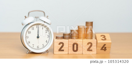 Happy New Year with vintage alarm clock and flipping 2023 change to 2024 block. Resolution, Goals, Plan, Action, Money Saving, Retirement fund, Pension, Investment and Financial concept 105314320