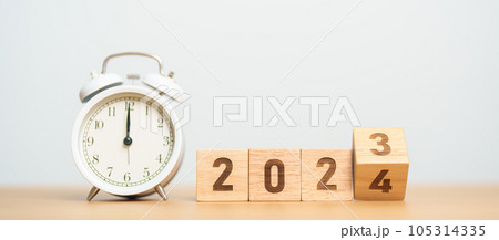 Happy New Year with vintage alarm clock and flipping 2023 change to 2024 block. Christmas, New Start, Resolution, countdown, Goals, Plan, Action and Motivation Concept Happy New Year with vintage alarm clock and flipping 2023 change to 2024 block. Christmas, New Start, Resolution, countdown, Goals, Plan, Action and Motivation Concept 105314335