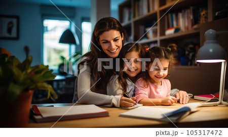 Happy child and adult are sitting at desk. Girl doing homework or online education 105317472