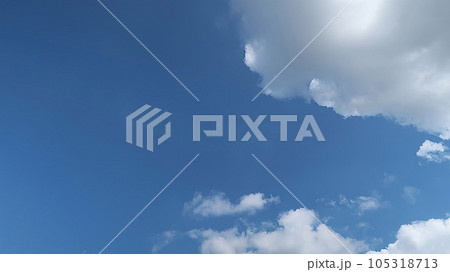 Heavenly white clouds on the blue sky with the sun appeared perfect for multimedia texture or background and content creation Heavenly white clouds on the blue sky with the sun appeared perfect for multimedia texture or background and content creation 105318713