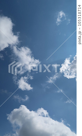 Heavenly white clouds on the blue sky with the sun appeared perfect for multimedia texture or background and content creation 105318714