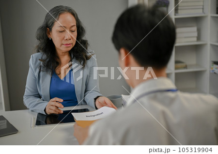 A businesswoman is talking about resigning and trying to compromise with a male employee 105319904