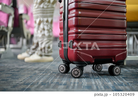 Close-up image of a red luggage on a plane aisle. journey, trip, vacation, transportation 105320409