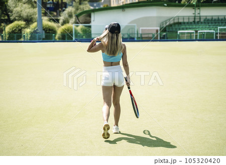 Tennis player woman on sport court in summer. Female sport, athlete body, healthy lifestyle concept. 105320420