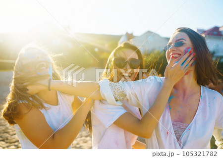 A group of friends have fun, dance at holi festival. Friendship, Leisure, Vacation, Togetherness. 105321782