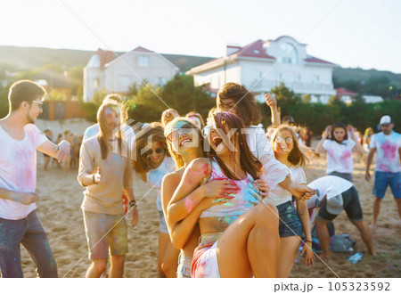 A group of friends have fun, dance at the holi festival. Celebrating traditional indian spring holiday. Friendship. 105323592