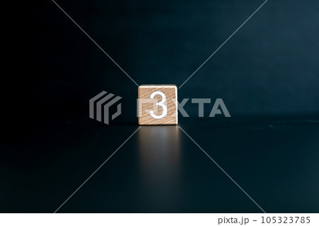 Wooden block written "3" with a Black background. Wooden block written "3" with a Black background. 105323785