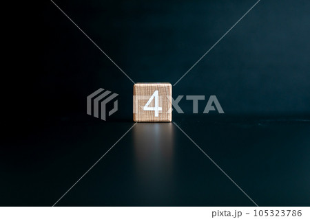 Wooden block written "4" with a Black background. Wooden block written "4" with a Black background. 105323786