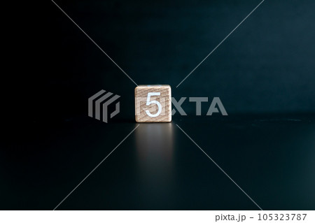 Wooden block written "5" with a Black background. Wooden block written "5" with a Black background. 105323787