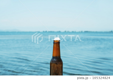 open beer bottle next to the water 105324824