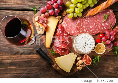 Assorted cold cuts with ham, salami, cheese, and wine. 105327001