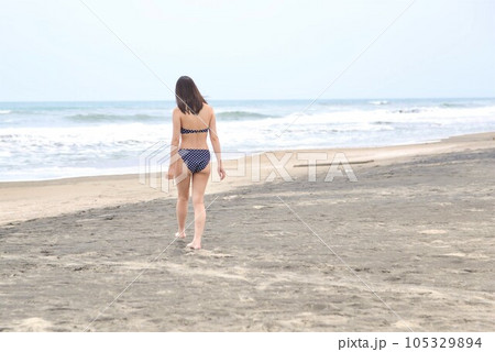 海岸にて水玉のビキニを着た若い女性の後ろ姿 105329894