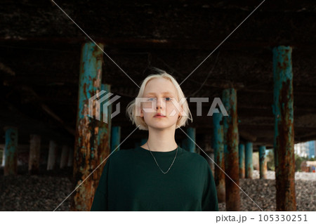 Strong young adult girl looking at camera outdoors 105330251