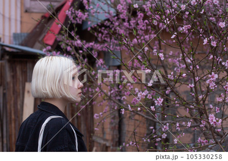 Beautiful blonde young adult woman outdoor portrait Beautiful blonde young adult woman outdoor portrait 105330258